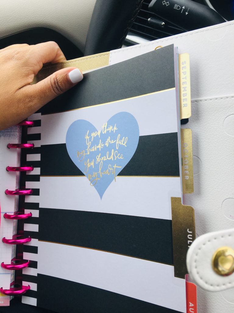 happy planner in car with a hand